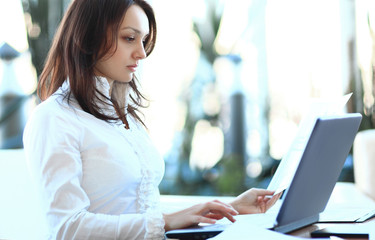 closeup. modern business woman working with documents sitting at her Desk