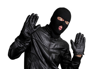 Fototapeta na wymiar Arrested masked thief with raised arms isolated on white background