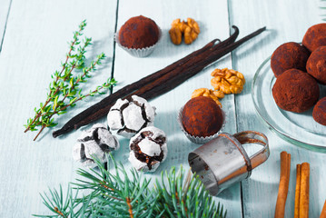 Christmas dessert chocolate truffles and spices on white wood