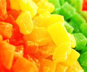 Bright yellow, green and orange candied pineapple fruit slices. 