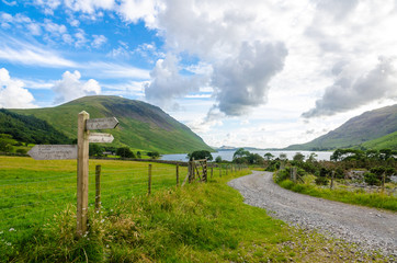 Path to the Wastwater lake with a sign post with directions to Scafell Pike, Eskdale and Miterdale, Wasdale Head and Lakeshore and Screes. Lake District, Cumbria