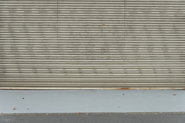 A closeup shot of automatic metal roller door used in factory, storage, garage, and industrial...