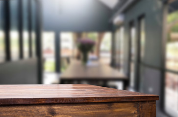 Selected focus empty brown wooden table and Coffee shop or restaurent blur background with bokeh image. for your photomontage or product display.