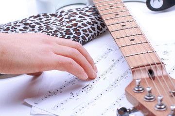 People playing guitar with musical chords in dark room