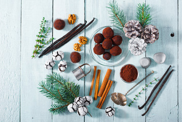 Christmas dessert chocolate truffles and spices on white wood