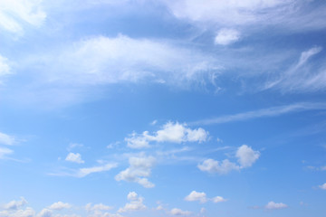 Naklejka na ściany i meble White puffy clouds on blue summer sky