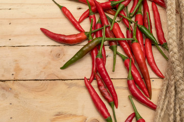 Hot and spicy red chilli on wood table background