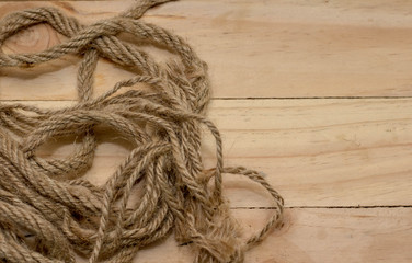 Aged rope on the old wooden pattern background