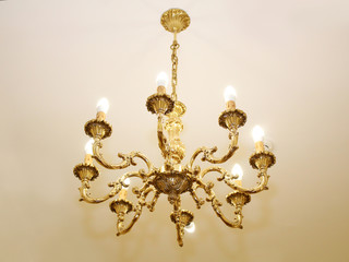 Beautiful vintage crystal chandelier in a room, golden object