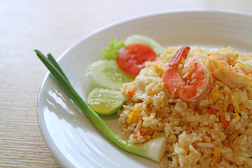 Popular Thai food Khao Pad Goong or Thai style fried rice with shrimp served on white plate