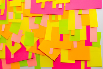 Bright multi-colored stickers on the office white board.