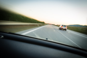 Fototapeta na wymiar Cars moving fast on a highway (motion blurred image)