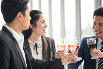 Colleague friends having fun and drinking cocktails in office together. Group of friends hanging out, New year party at the company