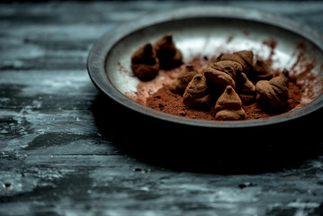 sweet, chocolate truffles and bitter cocoa on a romantic, dark background