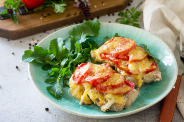Meat chops with tomato on stone table. Festive dinner or lunch.