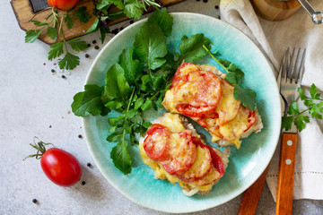 Meat chops with tomato on stone table. Festive dinner or lunch. Top view flat lay background.