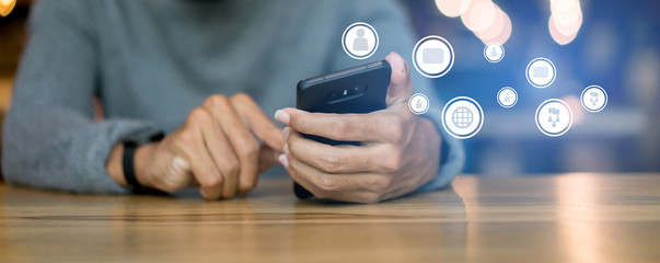 close up businessman hand touching on smartphone screen with networking connect effect for technology concept