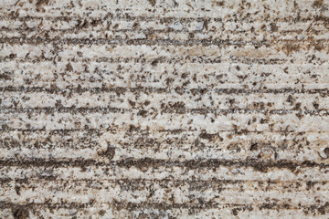 Light natural stone texture with horizontal lines, caverns and dots