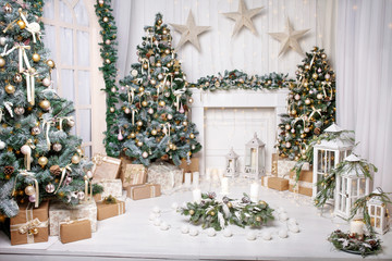 Christmas decor. Christmas tree decorations and holiday homes. New Year's interior with a fir tree in white tones