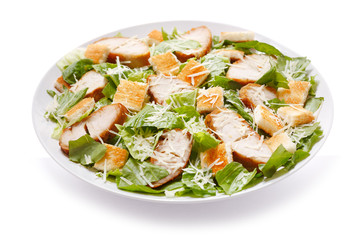 plate of chicken caesar salad on white background