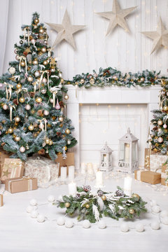 Christmas decor. Christmas tree decorations and holiday homes. New Year's interior with a fir tree in white tones