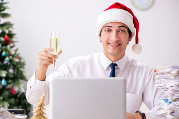 Young worker working in office on christmas shift