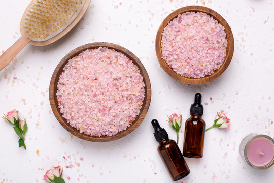 Rose Bath Salt And Natural Oil Bottles On White Background