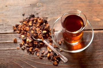 Turkish tea in traditional glass on wooden background. Selective focus.
