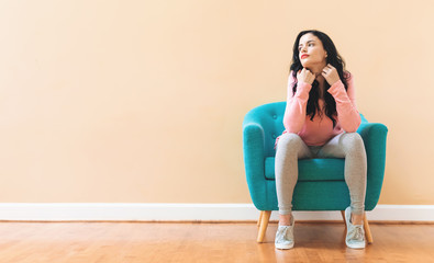 Portrait of a young woman in a chair