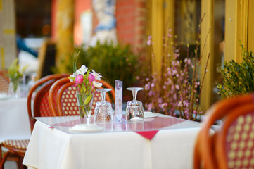 Small table set for dinner in outdoor cafe in Little Italy neighborhood in downtown Manhattan, New...