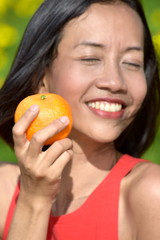 Smiling Youthful Diverse Female With An Orange