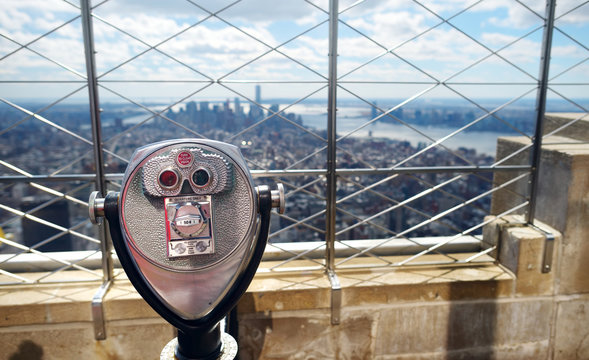 Tourist coin operated binoculars at the top of the Empire State Building in New York City - Powered by Adobe