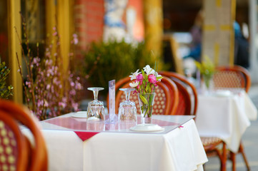 Small table set for dinner in outdoor cafe in Little Italy neighborhood in downtown Manhattan, New York City