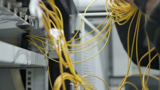 Technicians are installing optic fiber with cable ties.