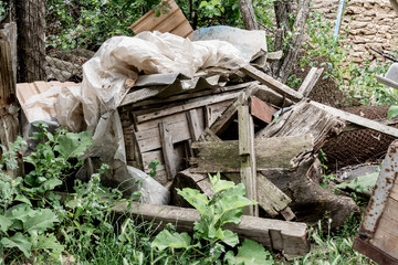 Rusty wire, old wooden boards and plastic film. Dump materials.