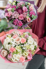 European floral shop. Two Bouquet of beautiful Mixed flowers in woman hand. Excellent garden flowers in the arrangement , the work of a professional florist.