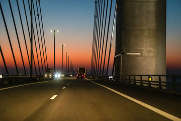 Oeresund bridge during crossing by car at sunrise