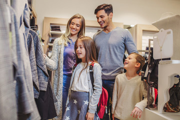 Naklejka premium Family shopping for clothes and looking happy