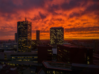 Skyscrappers with orange sky. Doom mood. Apocalyptics images of modern city. Sky in fire.