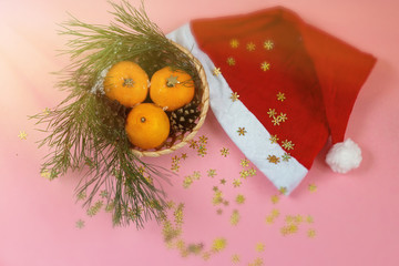 bright christmas template background with santa's hat and group of mandarins