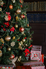 interior photo studio with Christmas decor. Fireplace, Christmas tree, gifts of the New Year's scenery