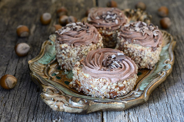 Naklejka premium Biscuit cake sprinkled with nut crumb and decorated with chocolate cream