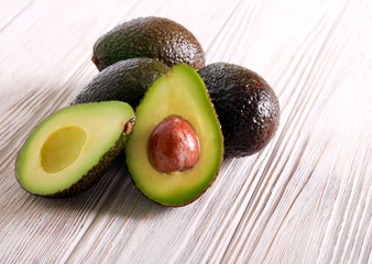 Avocados over wight wooden background