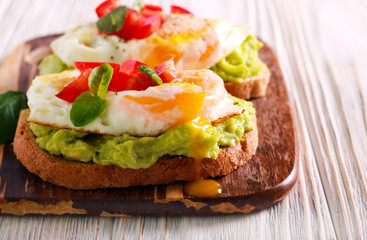 Fototapeta na wymiar Toasts with avocado and fried egg