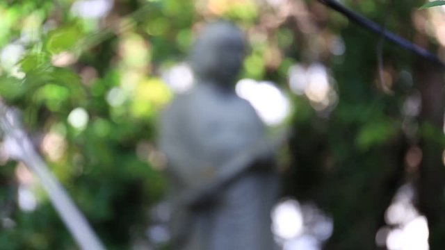 Japan, Beppu, 10 November 2017: Buddha figure made of stone standing in the Bush