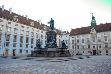 Fototapeta na wymiar Town square in Vienna Austria with a large monument containing four statues.