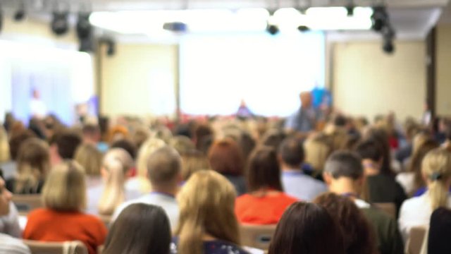people at a conference or presentation, workshop, master class photograph. Back view. It is a lot of people.