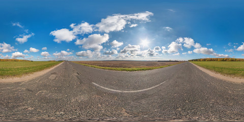 Full spherical seamless panorama 360 degrees angle view on no traffic asphalt road among fields in...