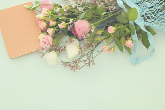 Fototapeta Image of aromatic flowers over pastel wooden table.