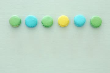 Top view of colorful macaron or macaroon over pastel background. Flat lay.